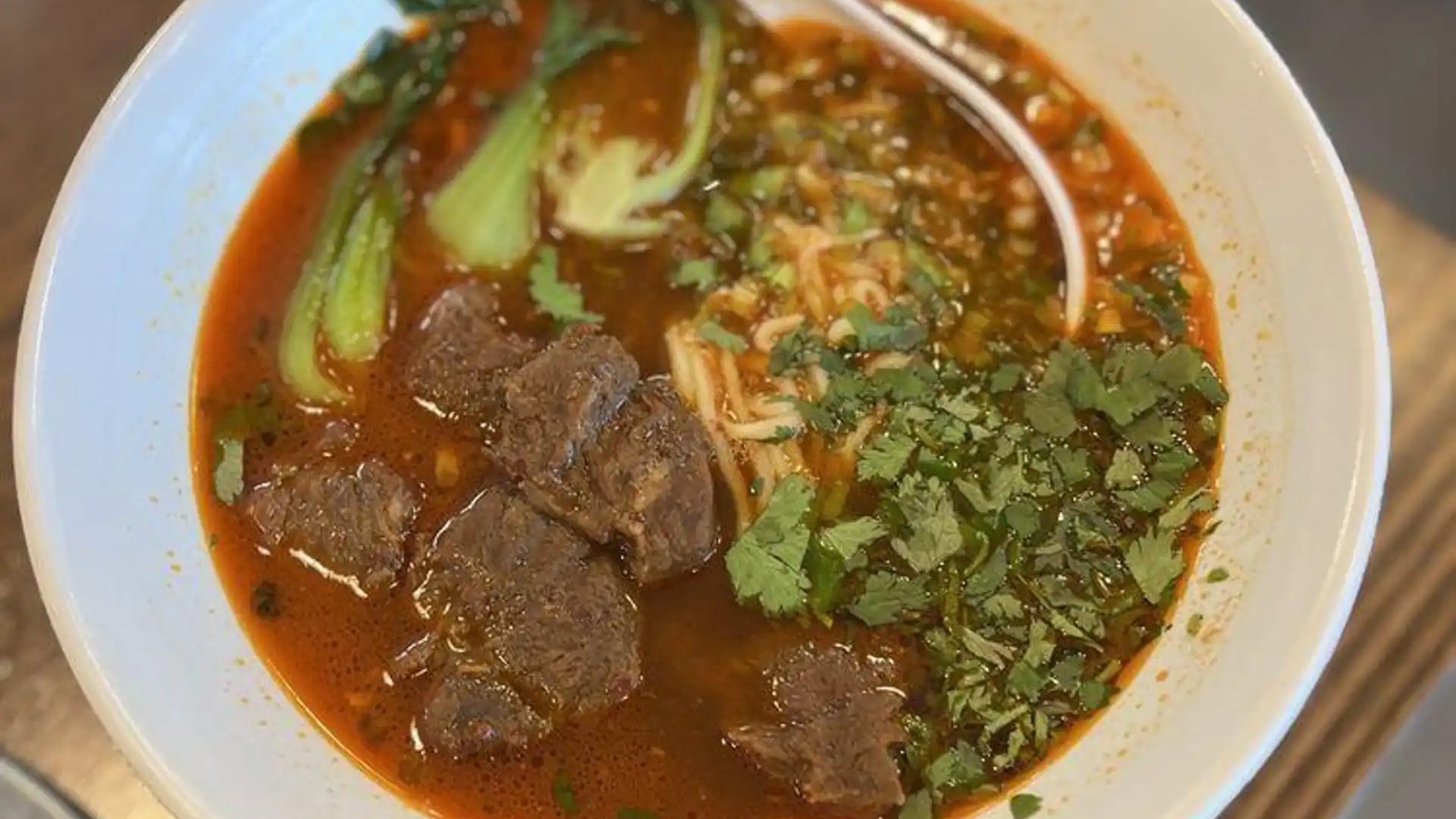 Braised beef noodle soup with bok choy and cilantro